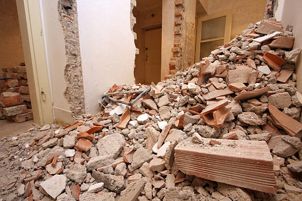 Bricks and mortar with broken walls and doors in the background.